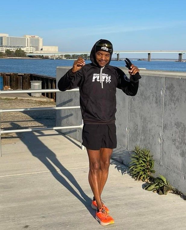 Al Taliaferro Jr. stretches as he prepares to run his 1,000th day straight. Photo Credit: Mark Tyler