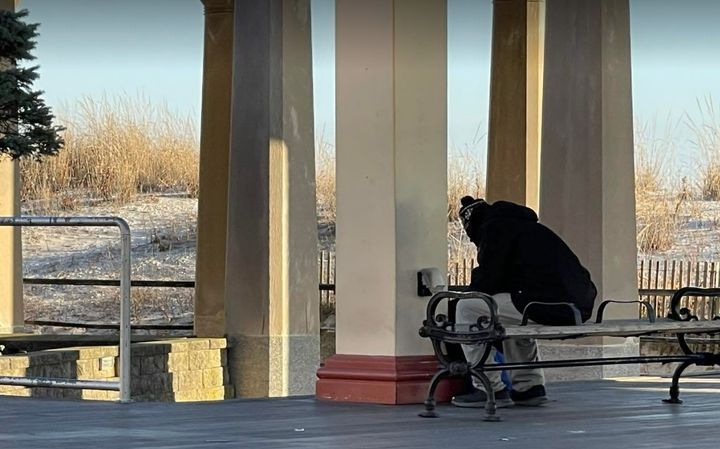 Homeless man sits in the cold on the Atlantic City Boardwalk. Photo Credit: Mark Tyler